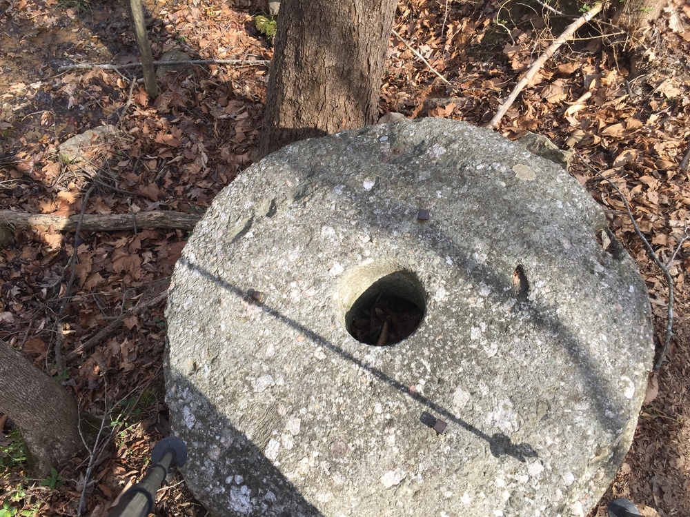 A millstone and other remnants of a former gristmill.